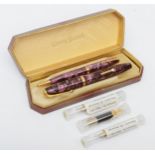 A Conway Stewart fountain pen with 14k gold nib with a matching propelling pencil, cased and three