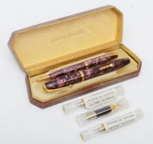 A Conway Stewart fountain pen with 14k gold nib with a matching propelling pencil, cased and three