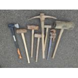 A collection of lump hammers and other tools