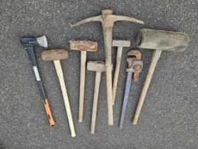 A collection of lump hammers and other tools