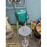 A Wilkinson powder coated wheel barrow, Jones treadle sewing machine base and a metal sundial (3)