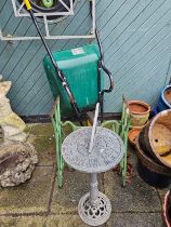 A Wilkinson powder coated wheel barrow, Jones treadle sewing machine base and a metal sundial (3)