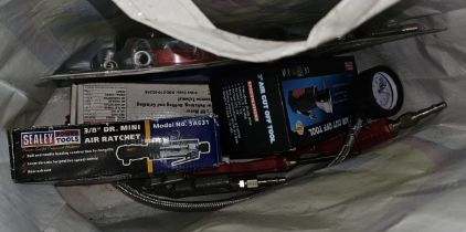 A bag of air tools, many unused.