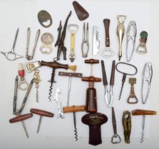 A collection of early 20th century and later corkscrews and bottle openers.