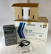 A Denon micro Hi-Fi system, with speakers, model D-C1 boxed as new condition.