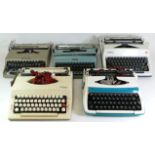 A collection of mid 20th century type writers.