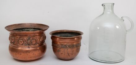 Two copper urns, together with a large glass measuring jug. (2)