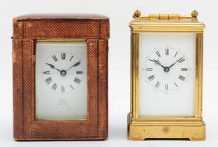 A brass cased 8 day carriage clock and a travel carriage clock.