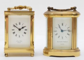 A brass cased oval 8 day carriage clock, 8 cm, together with another carriage clock.