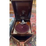 An early 20th century wind up gramophone by Dulceola, mahogany cased with a collection of 78rpm