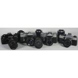 Four 35mm film cameras with lenses, to include a Praktica BC1 Electroinc with a Pentacon 70mm-
