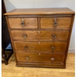 An Edwardian light oak chest of drawers, having two short over three long graduated drawers with