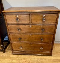 An Edwardian light oak chest of drawers, having two short over three long graduated drawers with