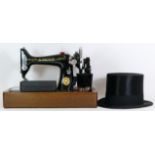 A cased Singer sewing machine and a cased Henry Heath top hat.