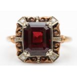 A 9ct gold garnet panel ring, the claws set with diamonds, 14 x 14 mm overall, L 1/2, 4gm