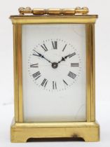 A mid 20th century carriage clock, brass cased with 8 day movement, Roman numerals to enameled face,