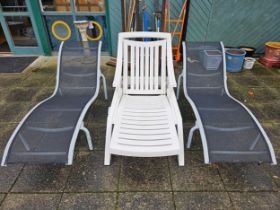 A pair of metal and fabric sun loungers and a plastic adjustable lounger