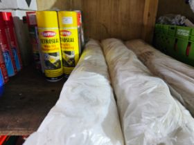 Various cans of wax oil rust proofing and 3 rolls of seat covers.