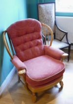 An Edwardian mahogany high back lounge chair, together with a later armchair. (2)