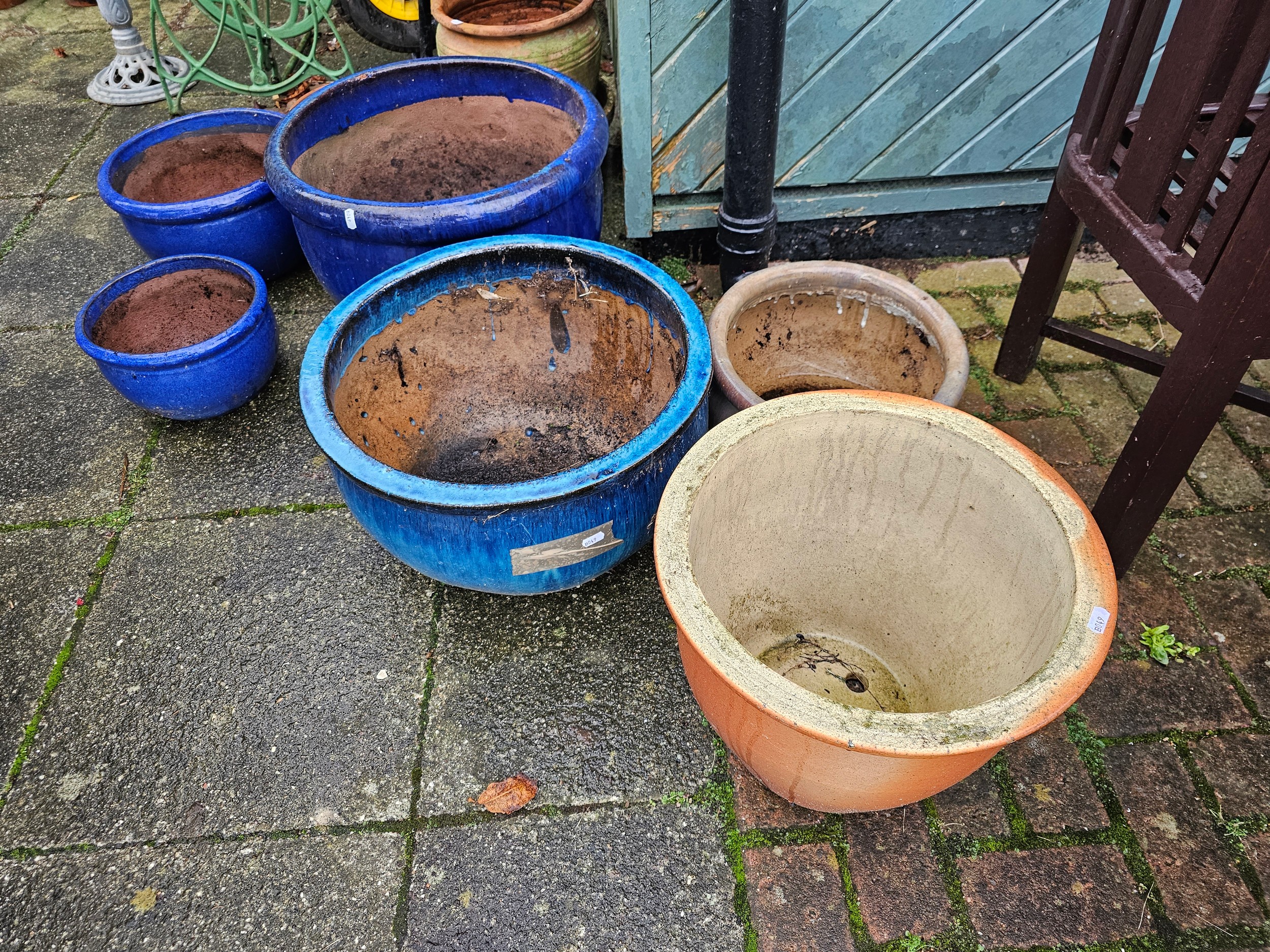 A collection of nine pottery and terracotta planters