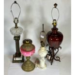 A collection of table lamps and shades, together with an Edwardian oil lamp.
