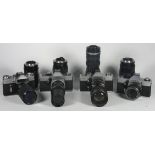 A collection of cameras and lenses to include the following: a Zenit-E with a Pentacon 80mm-200mm f4