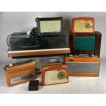 A collection of mid 20th century radios and audio equipment.