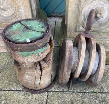 An early 20th century ships capstan together with a large wooden pulley. (2)