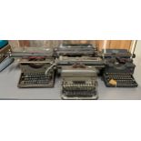Four metal cased early 20th century type writers.
