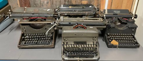 Four metal cased early 20th century type writers.