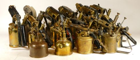 A large collection of early 20th century brass paraffin blow torches.