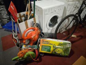 A Flymo leaf catcher, an electric hedge trimmer and various garden tools