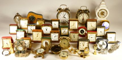 A collection of miniature novelty clocks, together with traveling alarm clocks, having manual and