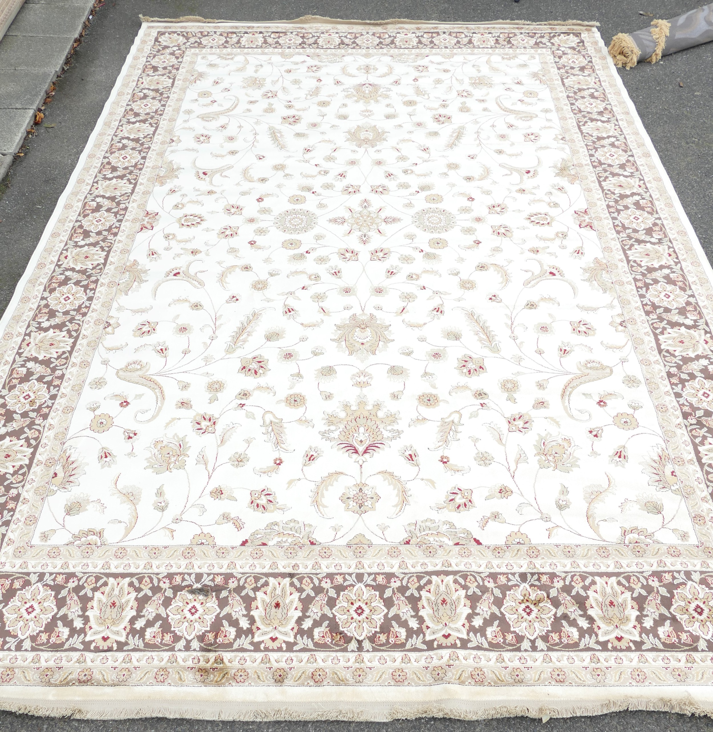 A Modern cream and brown ground floral carpet, 430 x 278cm, ex stock.