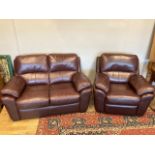 A modern brogue brown leather two seater sofa, 146 x 92cm, with a matching reclining arm chair. (2)