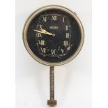 A vintage brushed metal cased Jaeger car clock, the black dial with white Roman numerals,