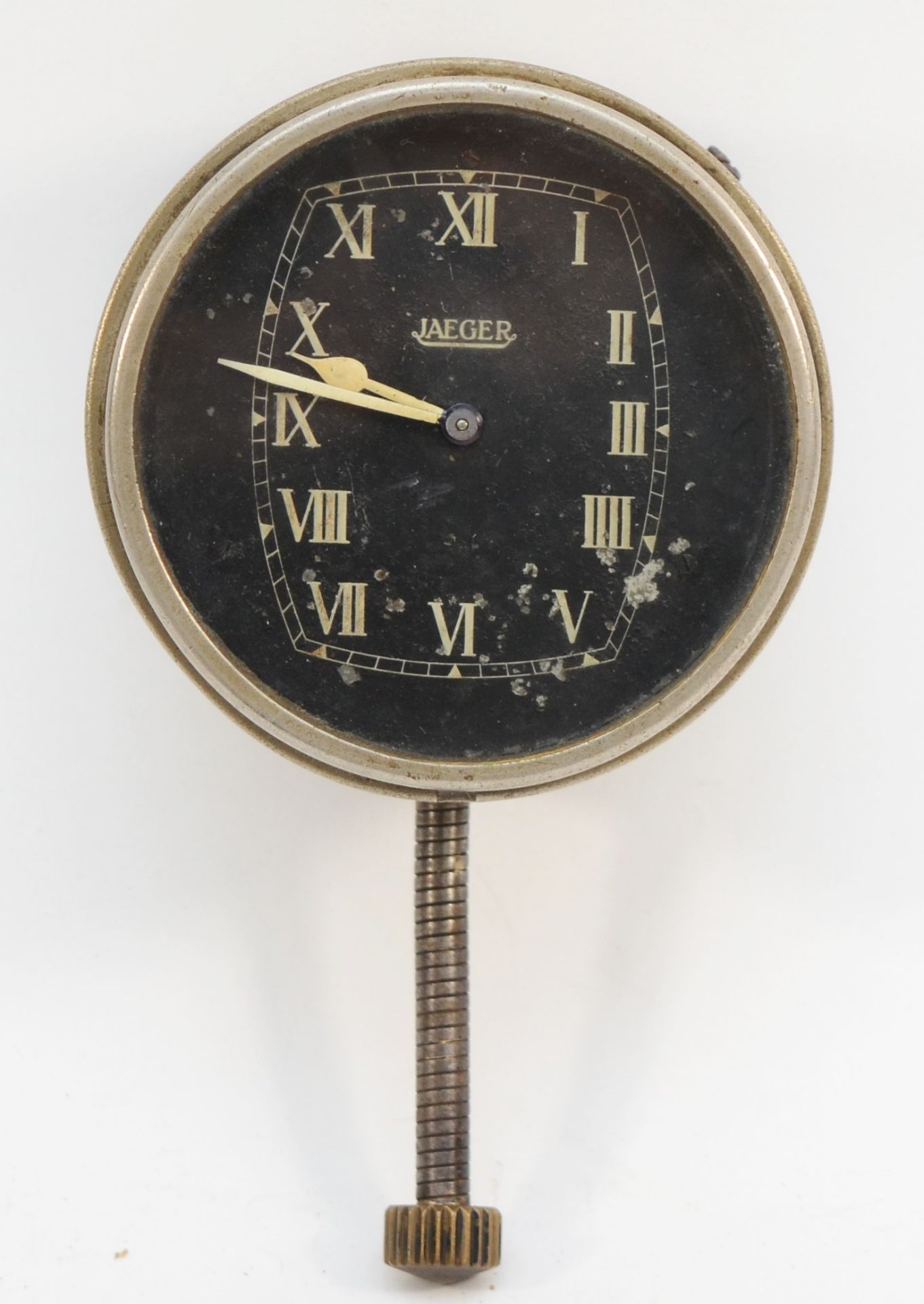 A vintage brushed metal cased Jaeger car clock, the black dial with white Roman numerals,