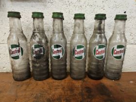 A set of six Castrol glass one pint bottles, all with caps