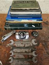 Four vintage Daimler spanners, and other Daimler related badges and books