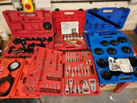 A 15 piece cup oil filter wrench set, a radio removal kit and other tools, mainly unused