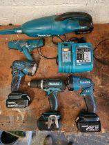 A Makita DC18RA charger, drill BHP452, two torches and a vacuum cleaner