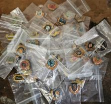 A collection of 39 car and bike tin lapel pins