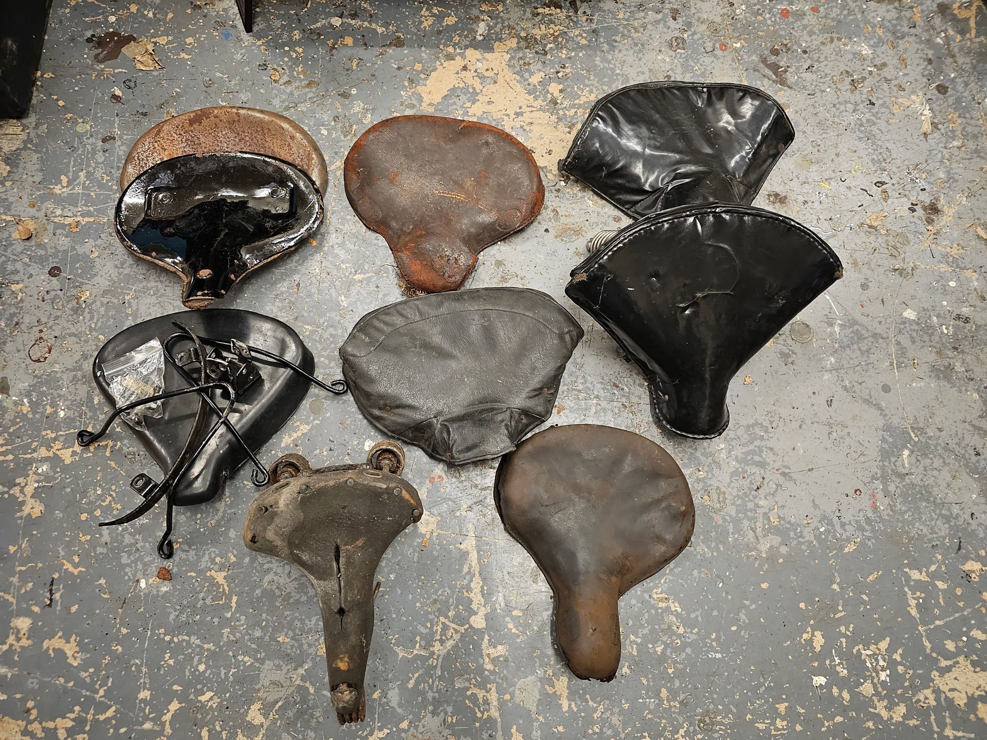 A Dunlop vintage seat and other various vintage motorcycle seats.