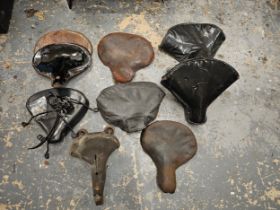 A Dunlop vintage seat and other various vintage motorcycle seats.