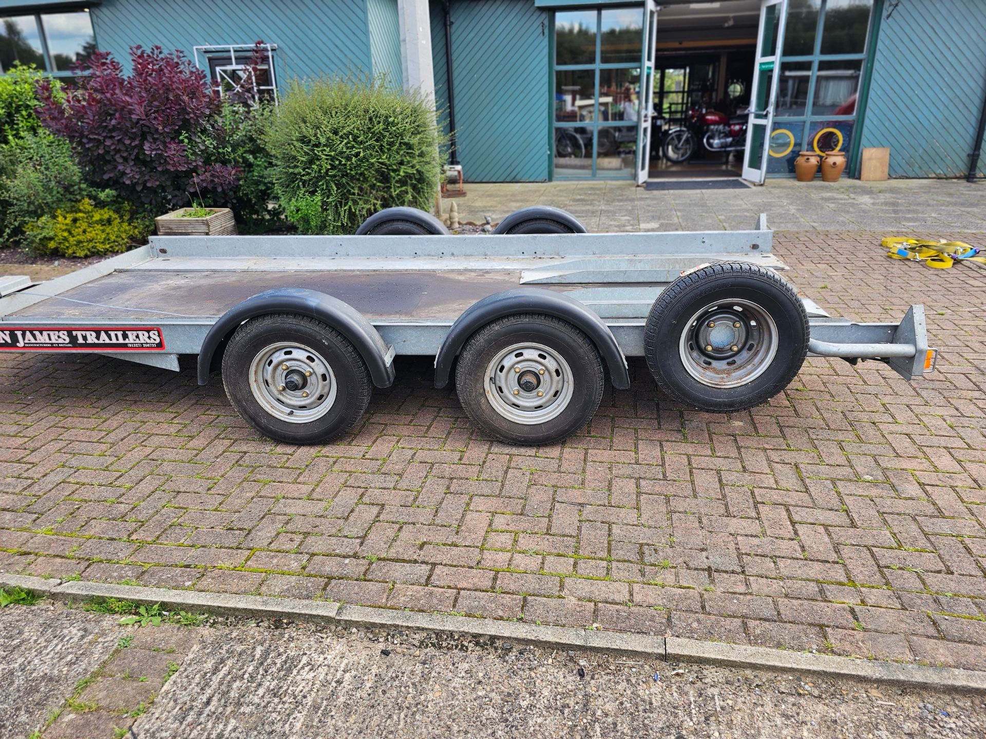 A Brian James, twin axle car trailer, up to 2700KG, with two ramps, manual winch and spare wheel. - Image 2 of 7