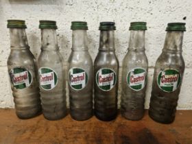 A set of six Castrol glass one pint bottles, all with caps