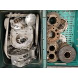 A collection of British motorcycle engine cases and cylinder heads.