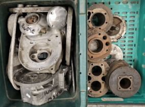 A collection of British motorcycle engine cases and cylinder heads.