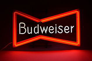 A neon sign advertising Budweiser, in the form of the Budweiser bowtie logo, 79 x 45 x 15cm