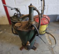 A green hand cranked forecourt pump and two other examples (3)